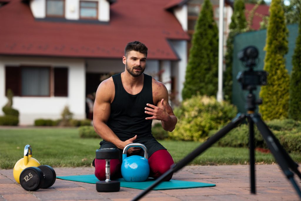 An online personal trainer recording a training video to share online.