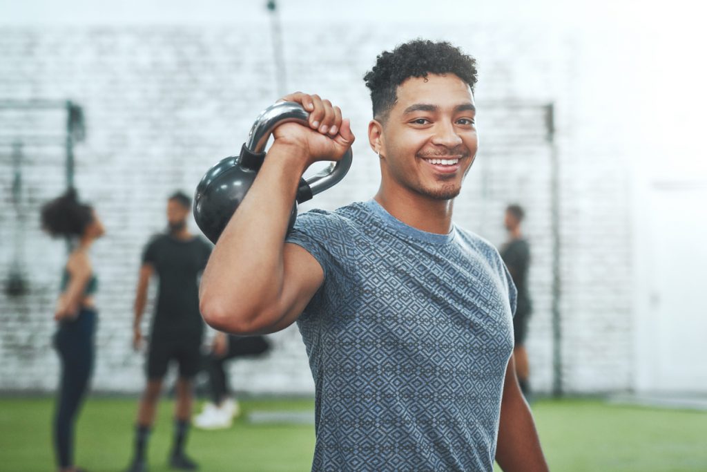 Personal trainer holding a kettlebell they have protected with personal trainer insurance. 