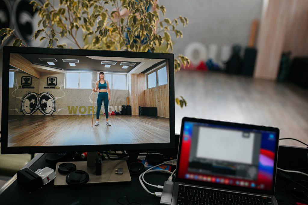 image of an online personal trainer through a screen, broadcasting live to their clients online