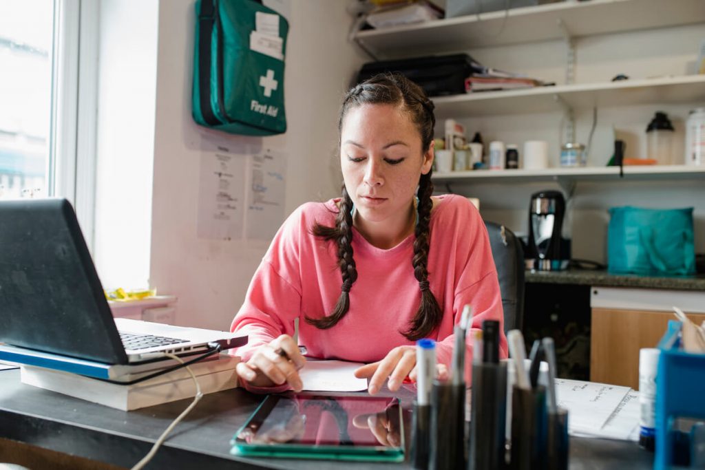 a female fitness professional performing administrative tasks at a desk 