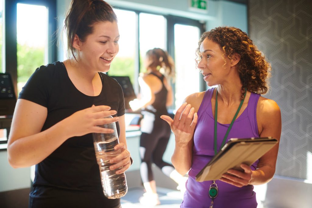 fitness professional and their client having a break during their session