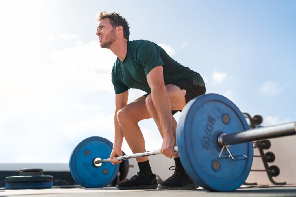 man deadlifting a barbell