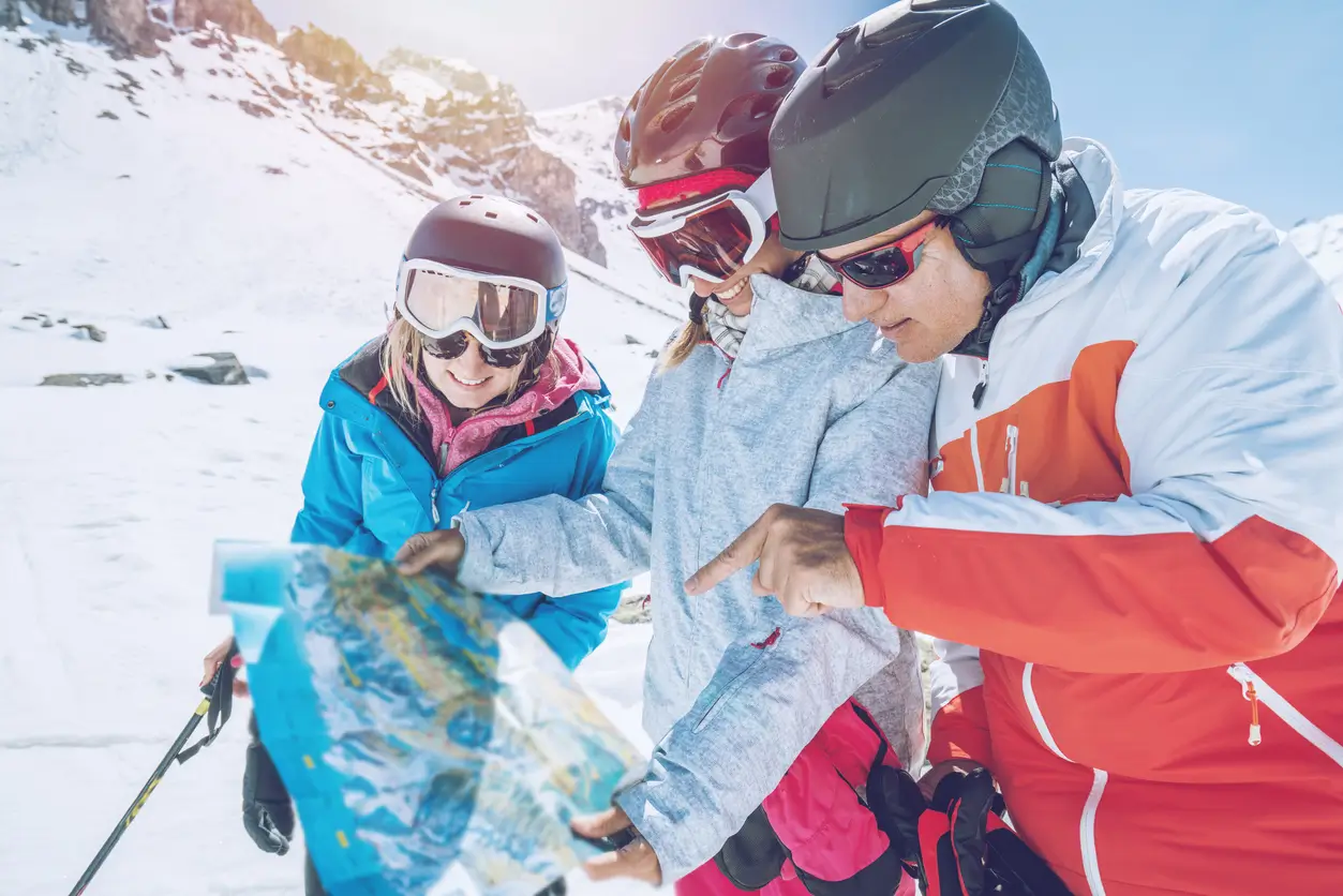 skiers looking at a map on a ski slope