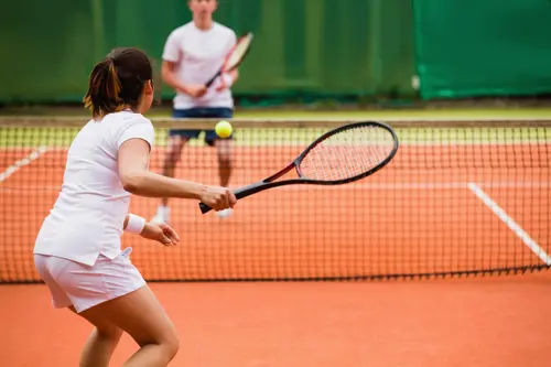 tennis player preparing to hit the ball back over the net