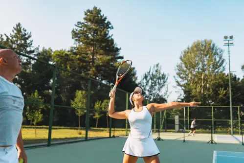 tennis player returning the ball over the net