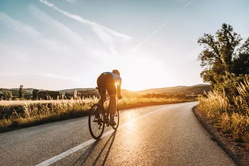 man cycling during sunset
