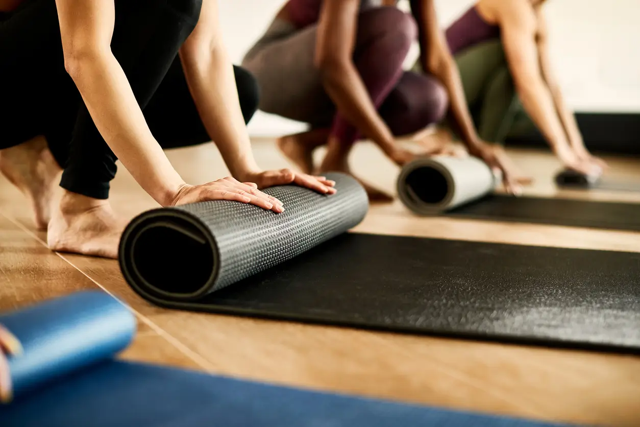 Pilates class rolling up their mats